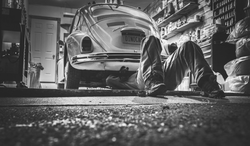 man repairing a beetle car